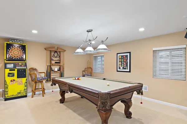 a room with pool table and a chandelier