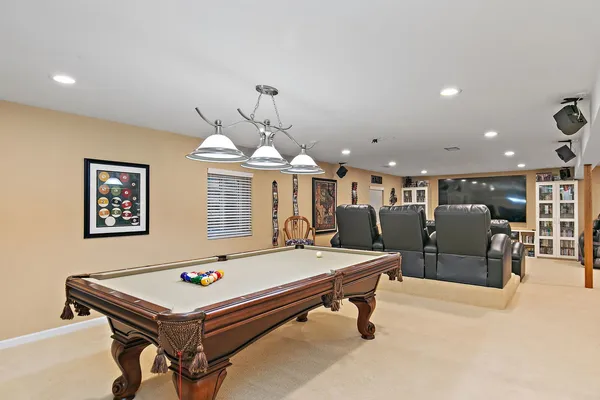 a room with pool table and windows