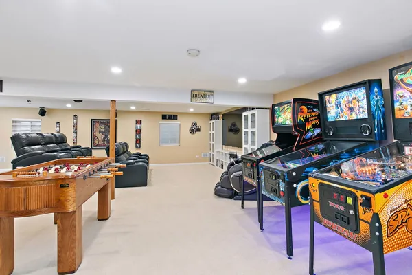 a living room with furniture a flat screen tv and a table