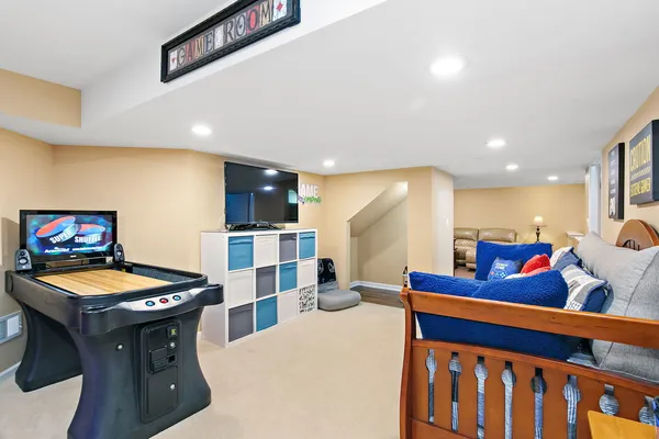a living room with furniture a table and kitchen view