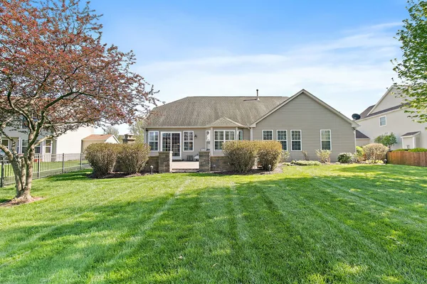 a front view of house with yard and green space