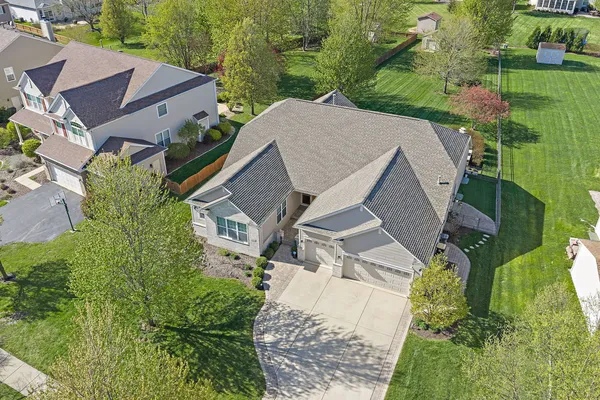 an aerial view of a house with a yard