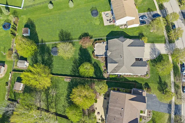 an aerial view of a houses with yard