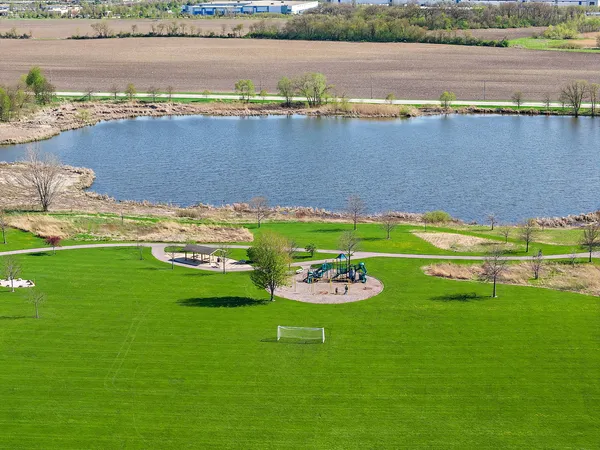 a view of a lake with lawn chairs