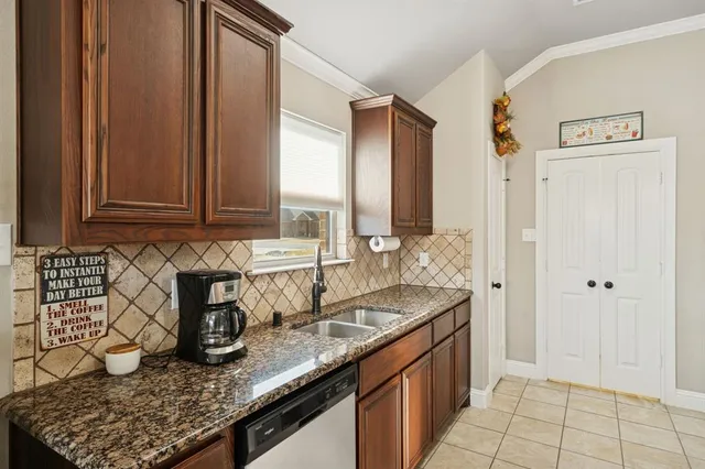 a kitchen with stainless steel appliances granite countertop a sink stove and cabinets
