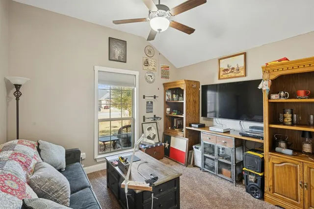 a living room with furniture a flat screen tv and gym equipment