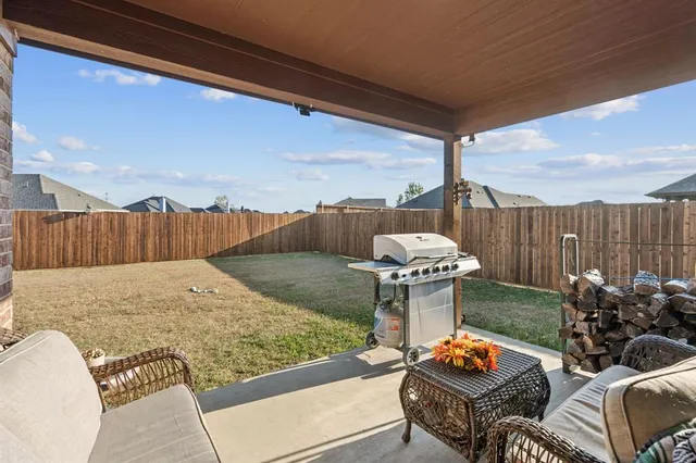 a backyard of a house with table and chairs