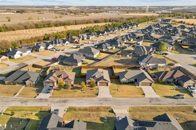 an aerial view of residential houses with outdoor space