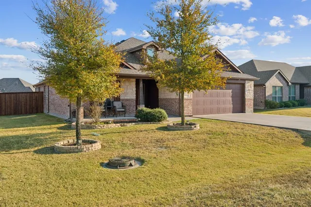 a front view of a house with a yard garage and outdoor seating