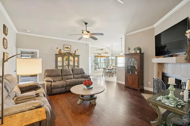 a living room with fireplace furniture and a flat screen tv