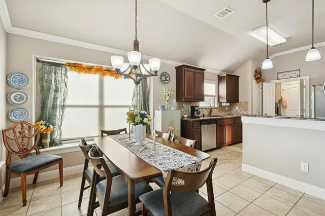a kitchen with a table and chairs in it