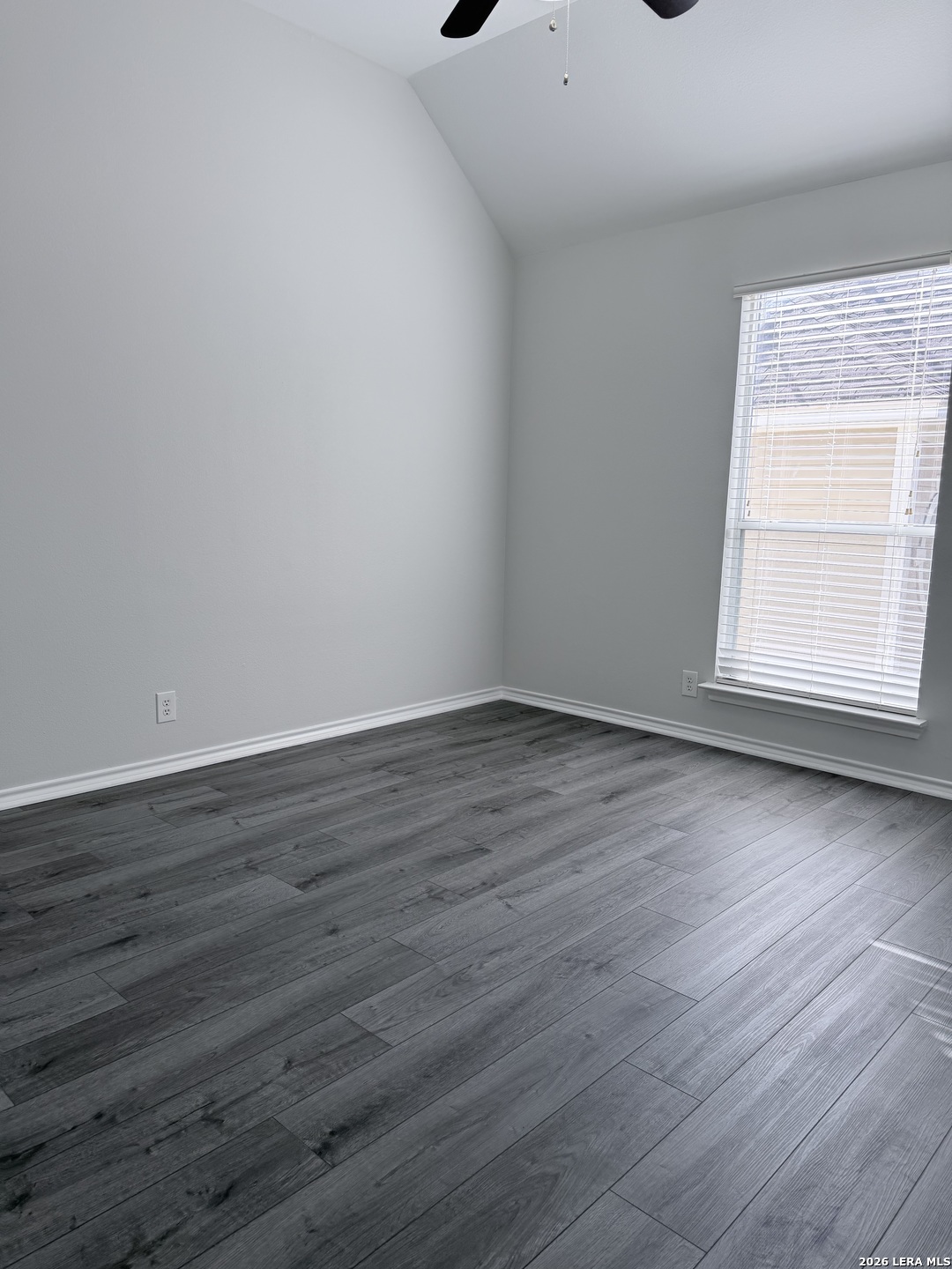 6736 Terra Rye San Antonio, TX 78240 - Photo 11 of 26 a view of an empty room with wooden floor and a window