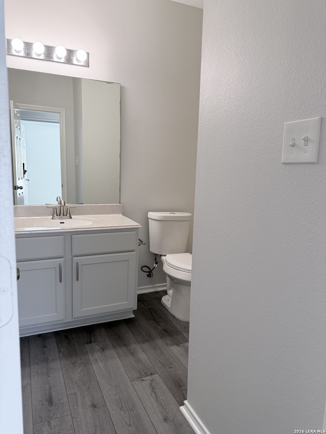 6736 Terra Rye San Antonio, TX 78240 - Photo 13 of 26 a bathroom with a toilet a sink and mirror