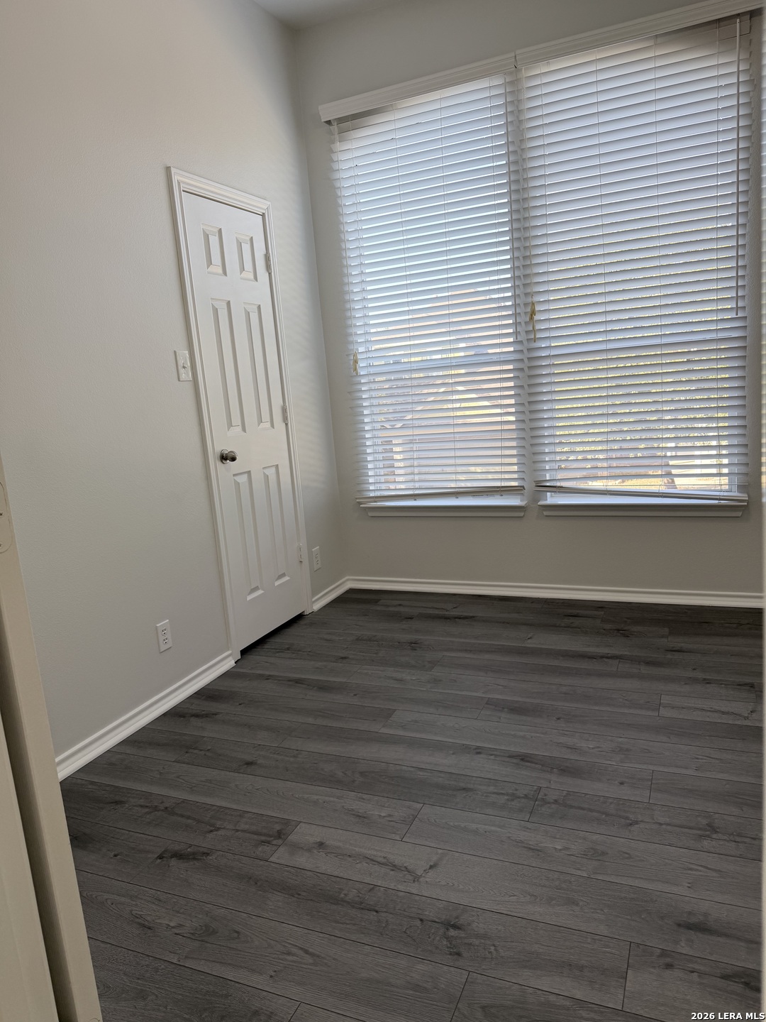 6736 Terra Rye San Antonio, TX 78240 - Photo 14 of 26 a view of an empty room with wooden floor and a window