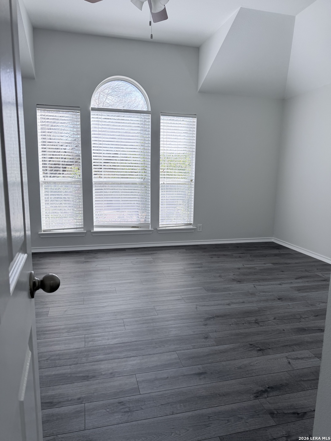 6736 Terra Rye San Antonio, TX 78240 - Photo 16 of 26 an empty room with wooden floor and windows