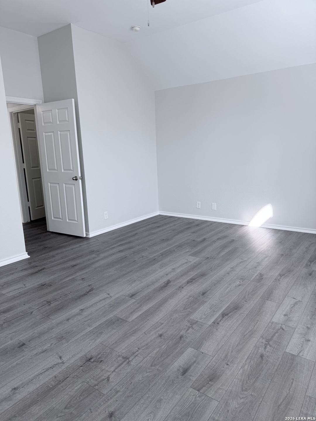 6736 Terra Rye San Antonio, TX 78240 - Photo 17 of 26 a view of an empty room with wooden floor and a window