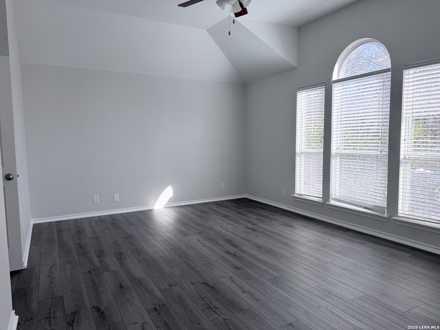 6736 Terra Rye San Antonio, TX 78240 - Photo 19 of 26 an empty room with wooden floor and windows