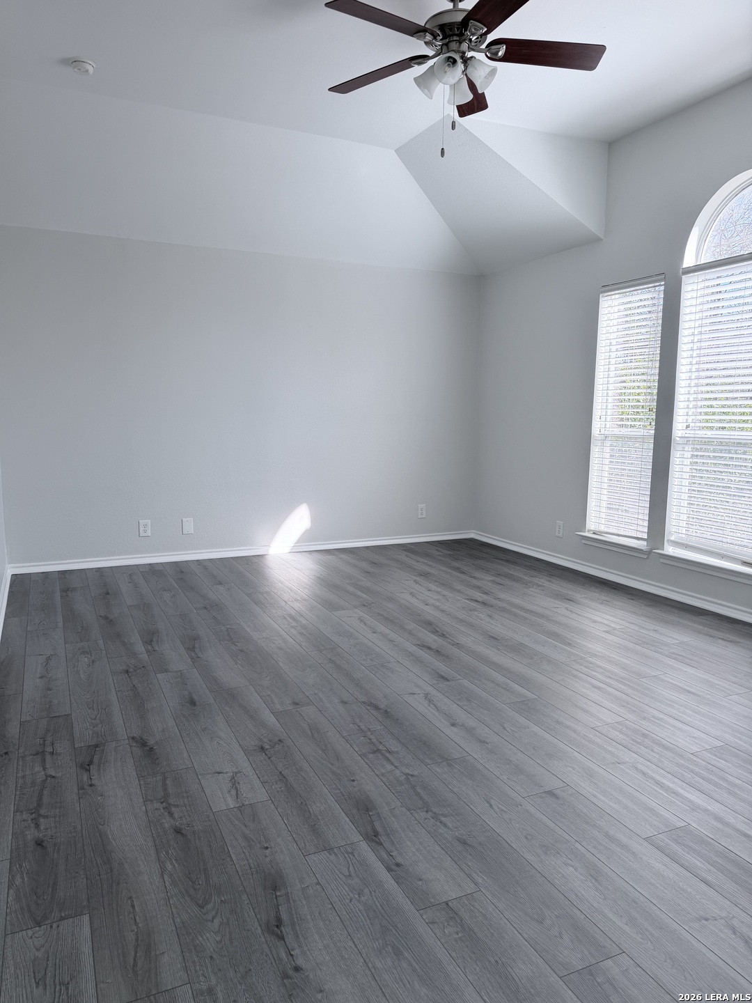 6736 Terra Rye San Antonio, TX 78240 - Photo 21 of 26 an empty room with wooden floor fan and windows