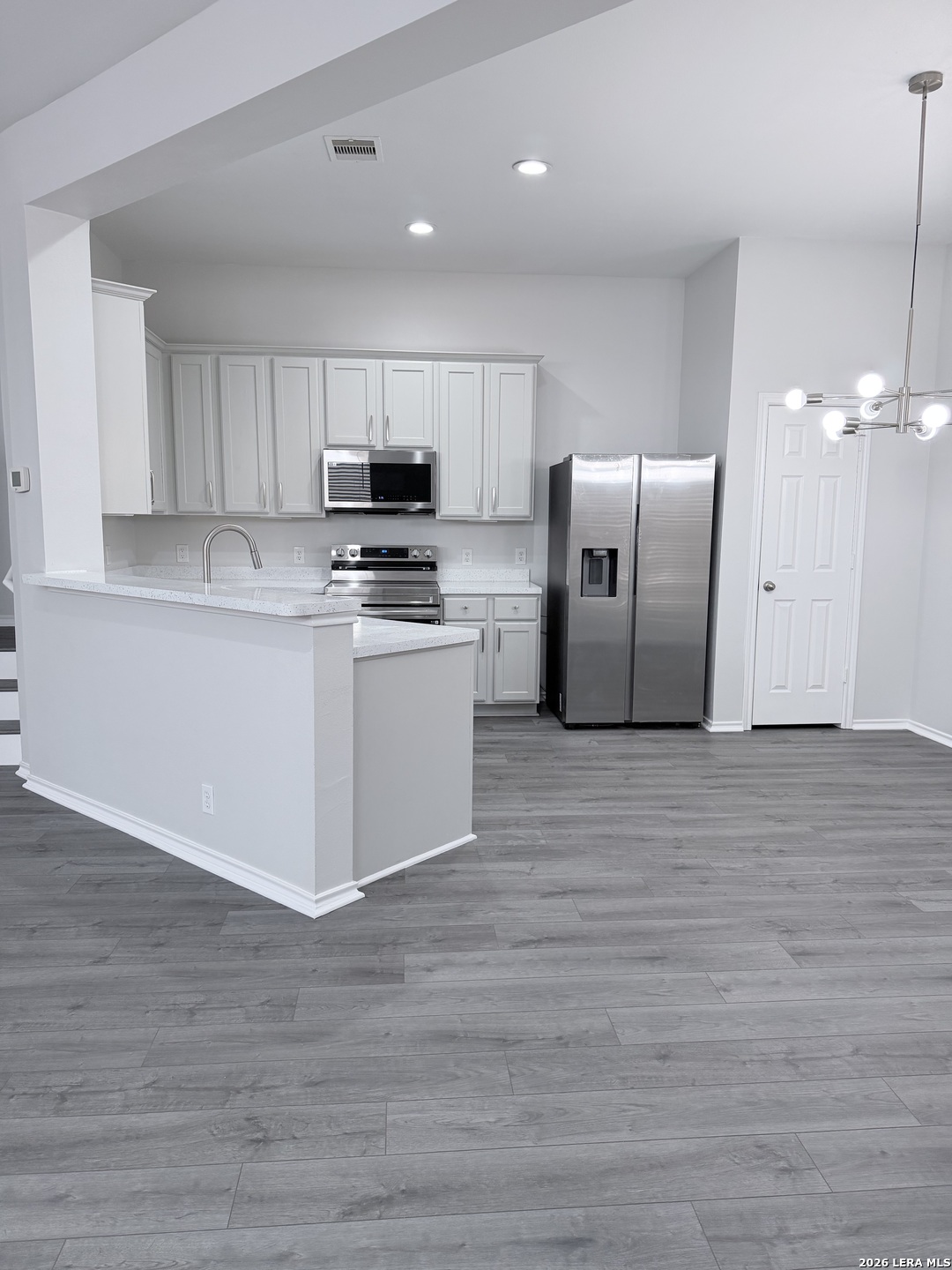 6736 Terra Rye San Antonio, TX 78240 - Photo 3 of 26 a kitchen with stainless steel appliances granite countertop a refrigerator a stove a sink and a microwave