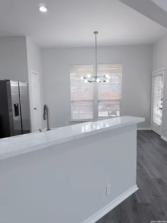 a view of a kitchen with a sink and wooden floor
