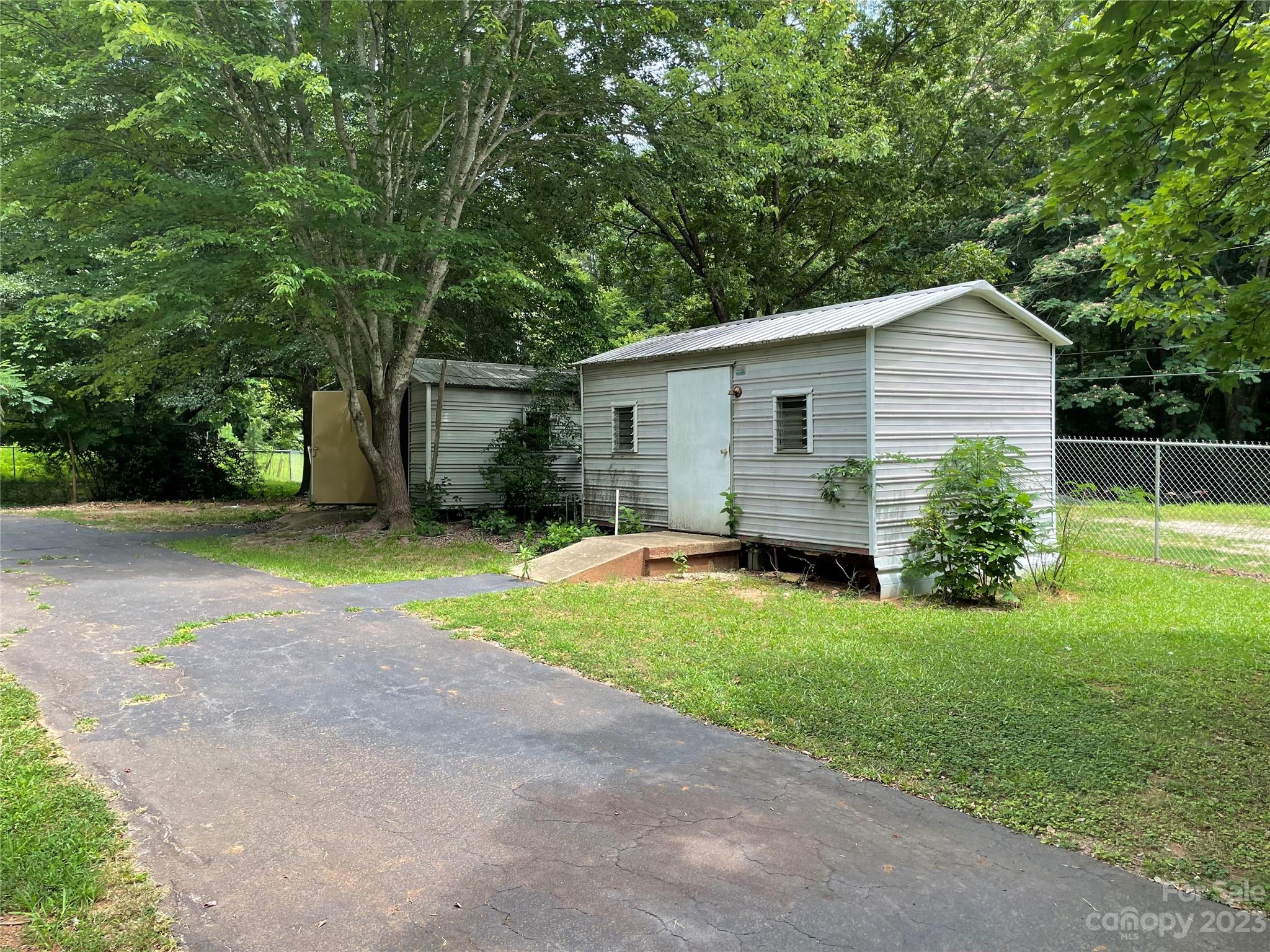 1125 Dunlap Roddey Road Rock Hill, SC 29730 - Photo 25 of 28 a view of a backyard with plants and large tree