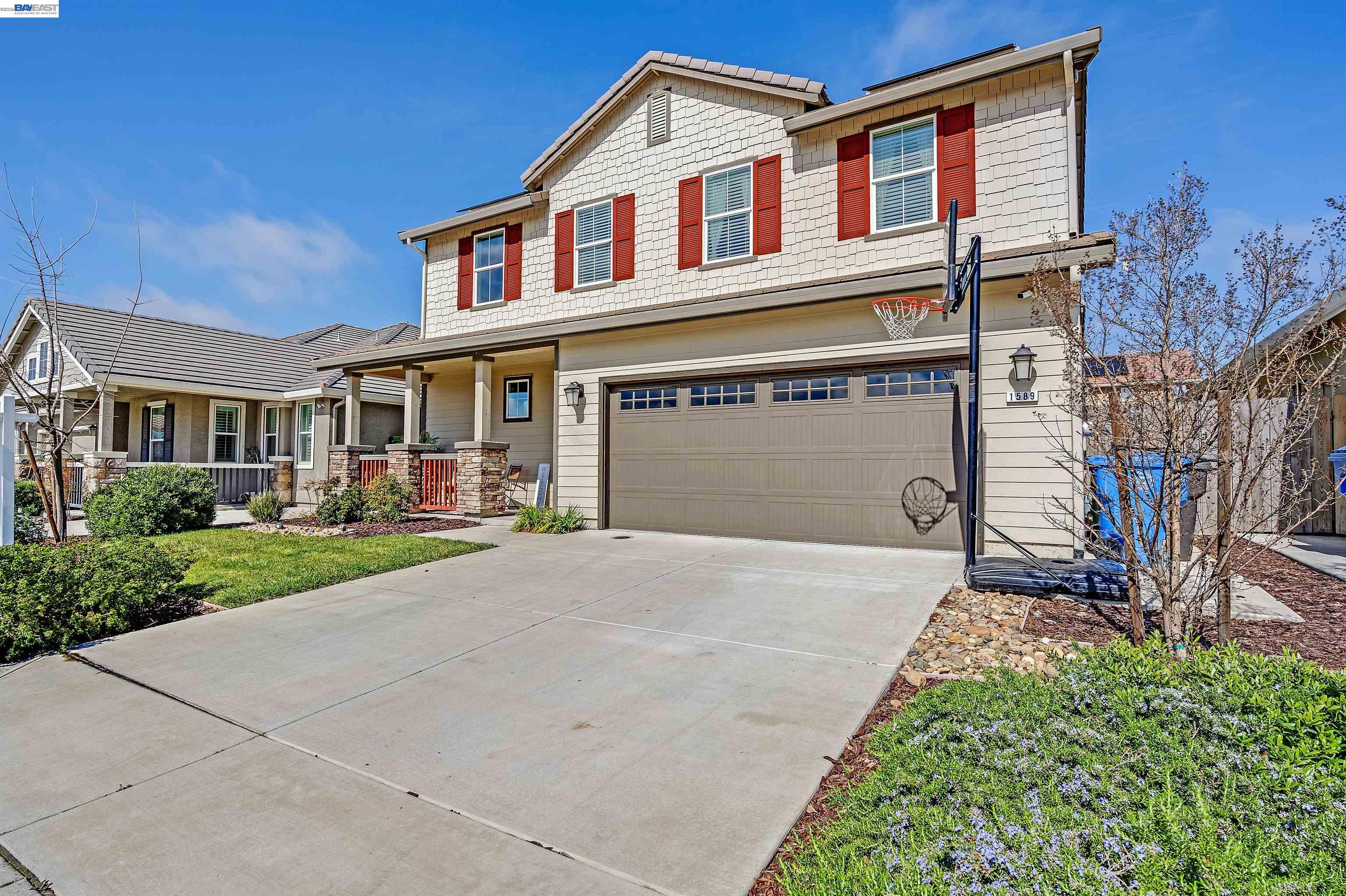 1589 Friendly Street Manteca, CA 95337 - Photo 1 of 50 a front view of a house with a yard and garage