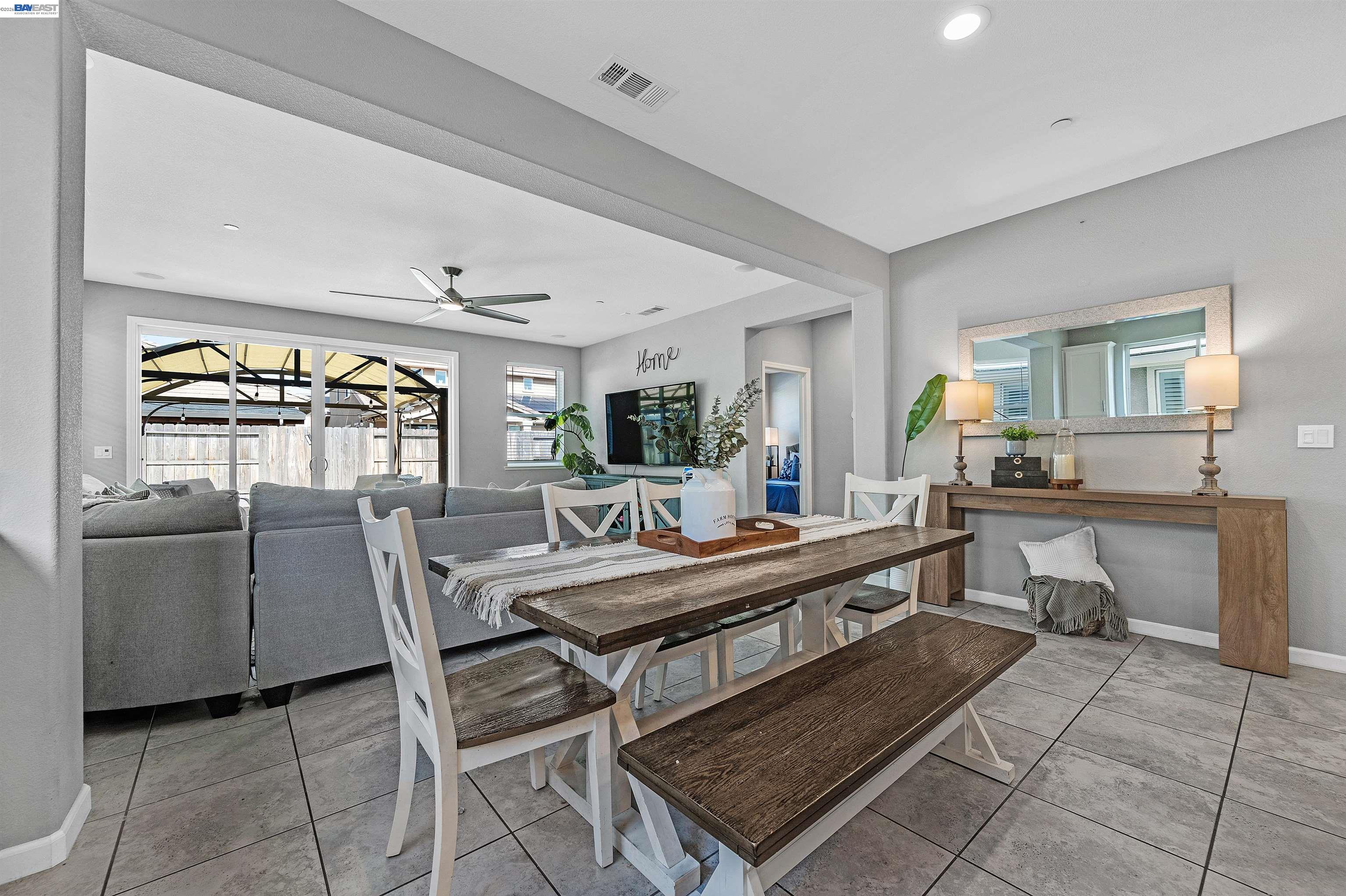 1589 Friendly Street Manteca, CA 95337 - Photo 13 of 50 a dining hall with stainless steel appliances granite countertop a stove a sink a dining table and chairs