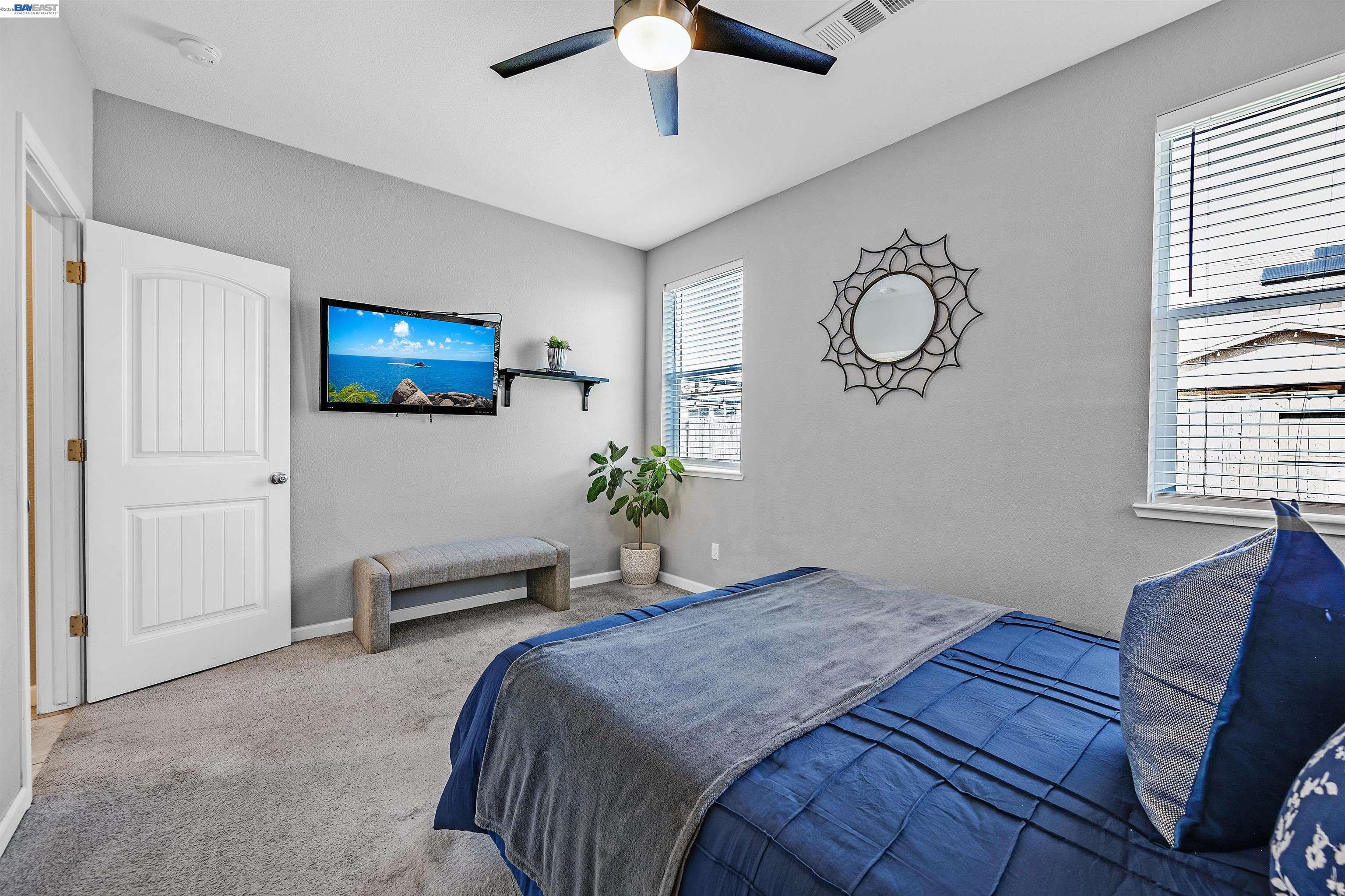 1589 Friendly Street Manteca, CA 95337 - Photo 19 of 50 a bedroom with a bed and a chandelier