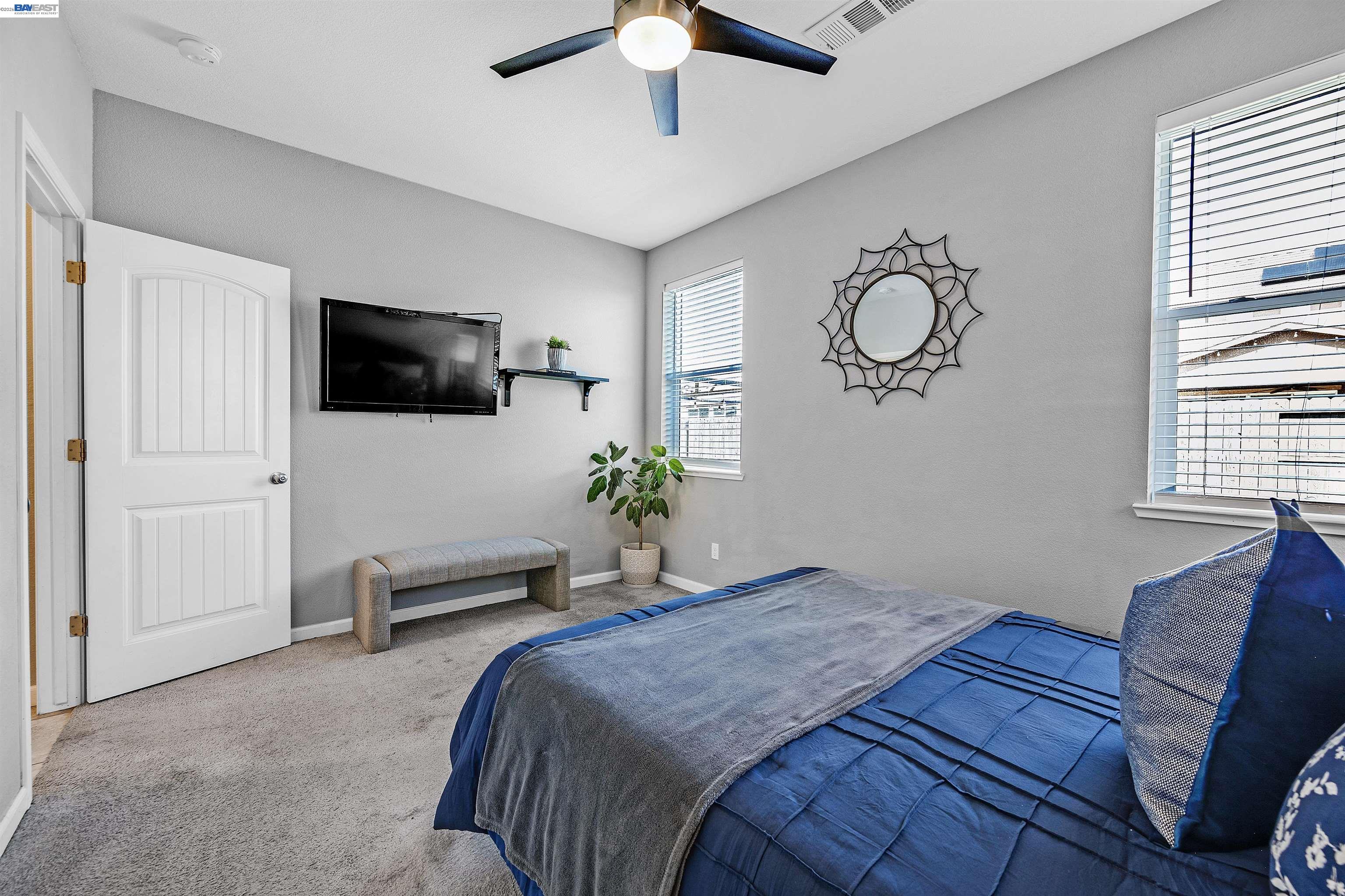 1589 Friendly Street Manteca, CA 95337 - Photo 20 of 50 a bedroom with a bed window and a flat screen tv