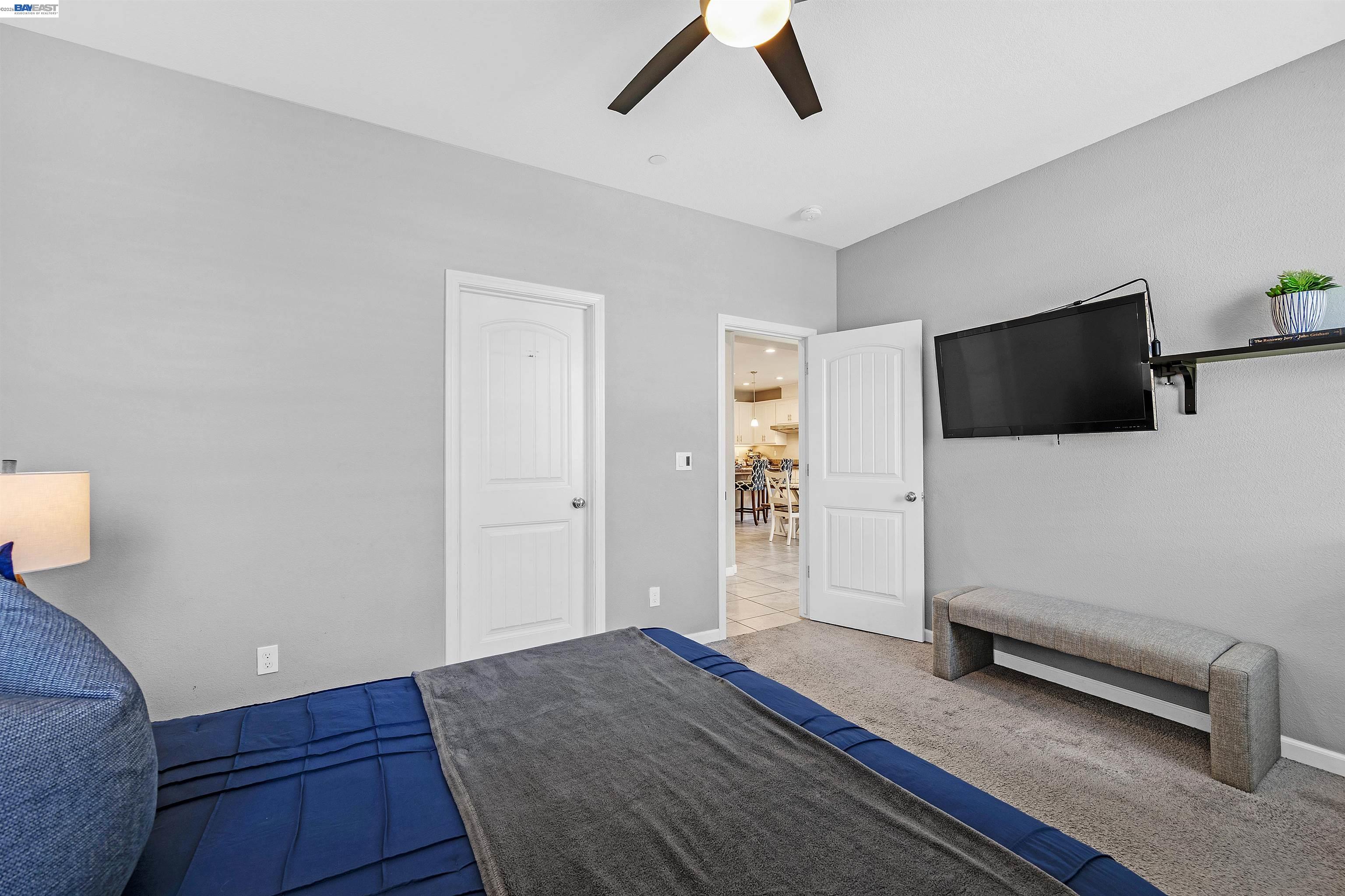 1589 Friendly Street Manteca, CA 95337 - Photo 22 of 50 a bedroom with furniture and a flat screen tv