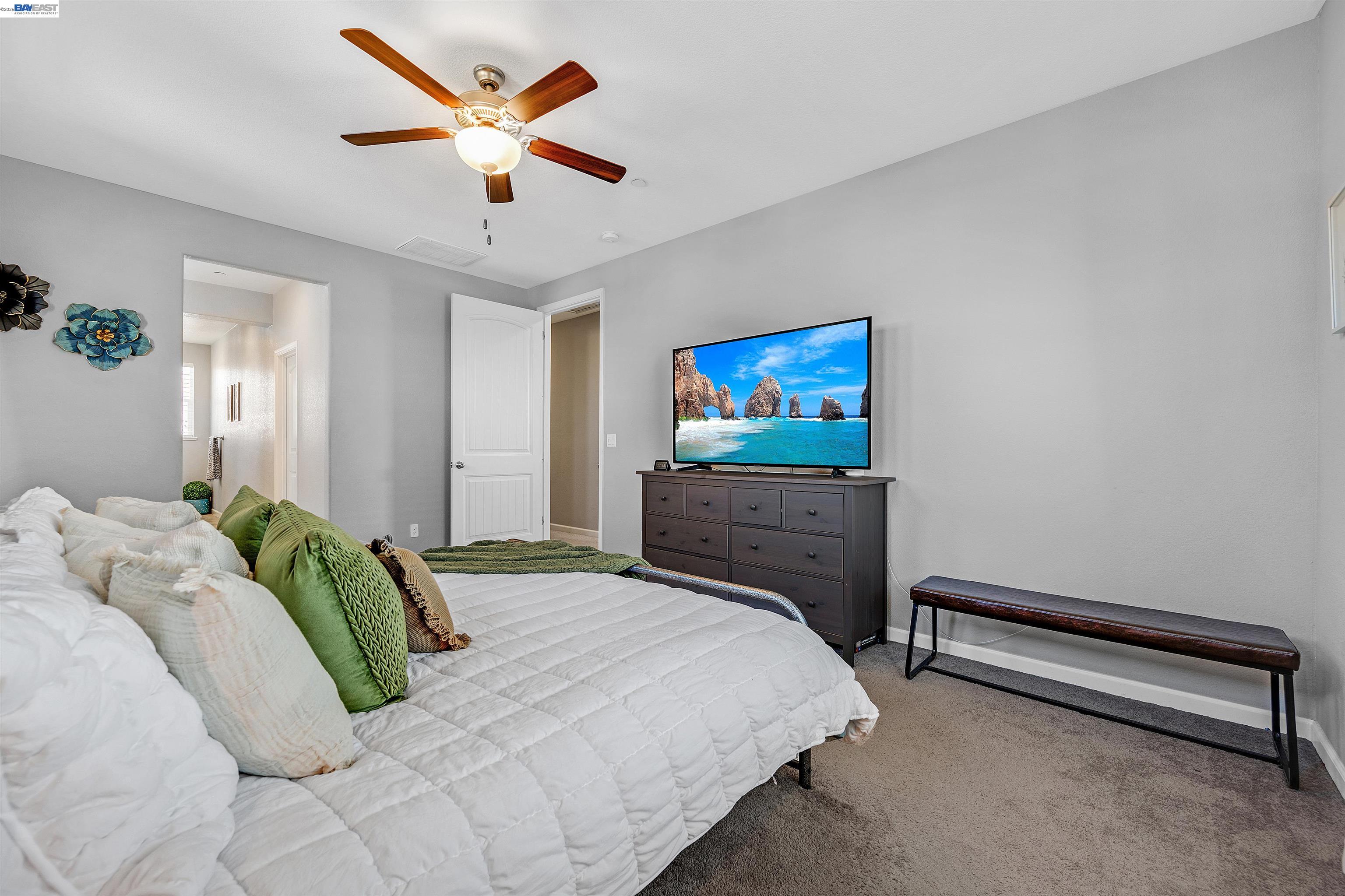 1589 Friendly Street Manteca, CA 95337 - Photo 27 of 50 a bedroom with a bed and a ceiling fan