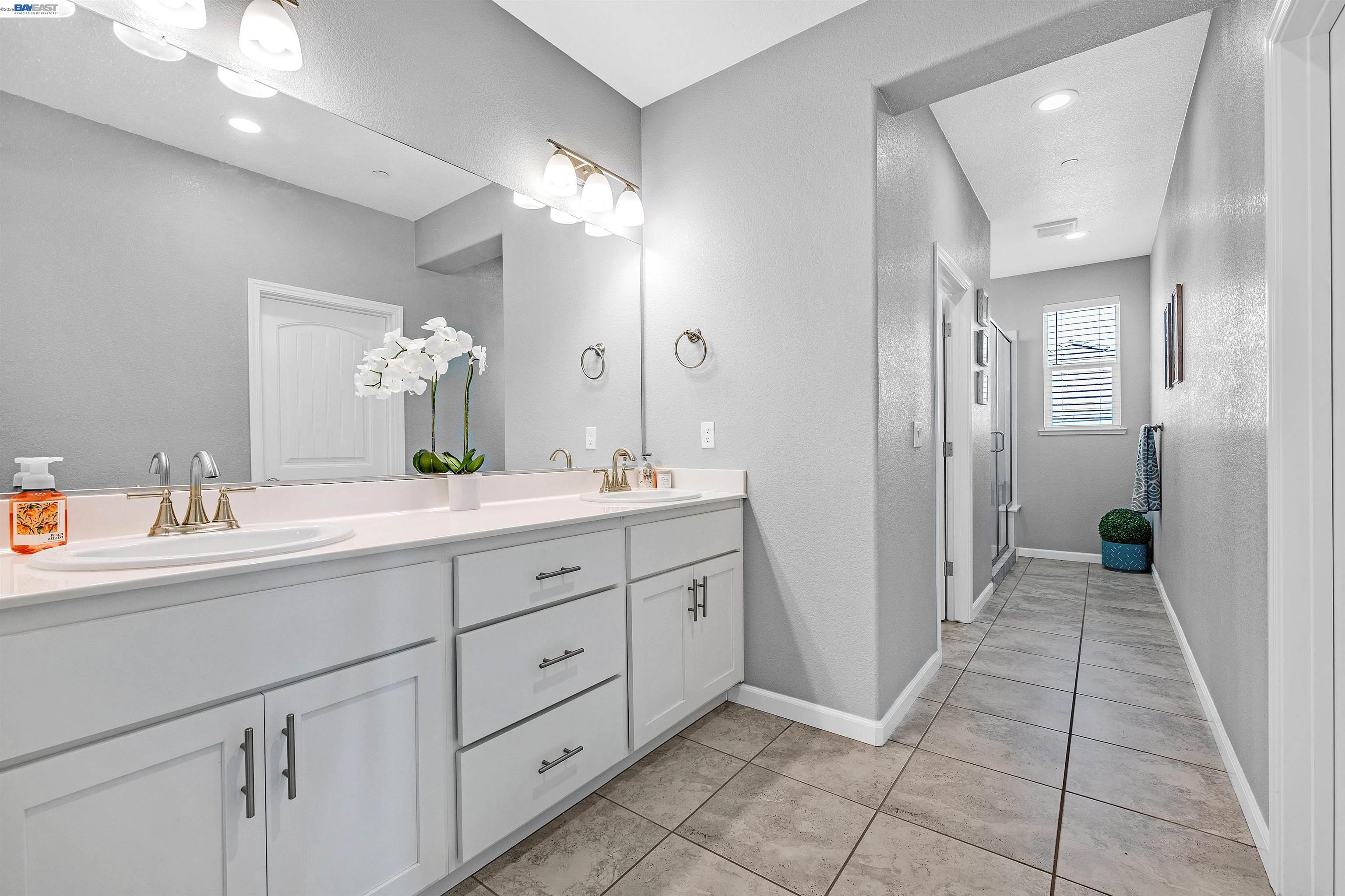 1589 Friendly Street Manteca, CA 95337 - Photo 31 of 50 a spacious bathroom with a granite countertop sink mirror and a shower