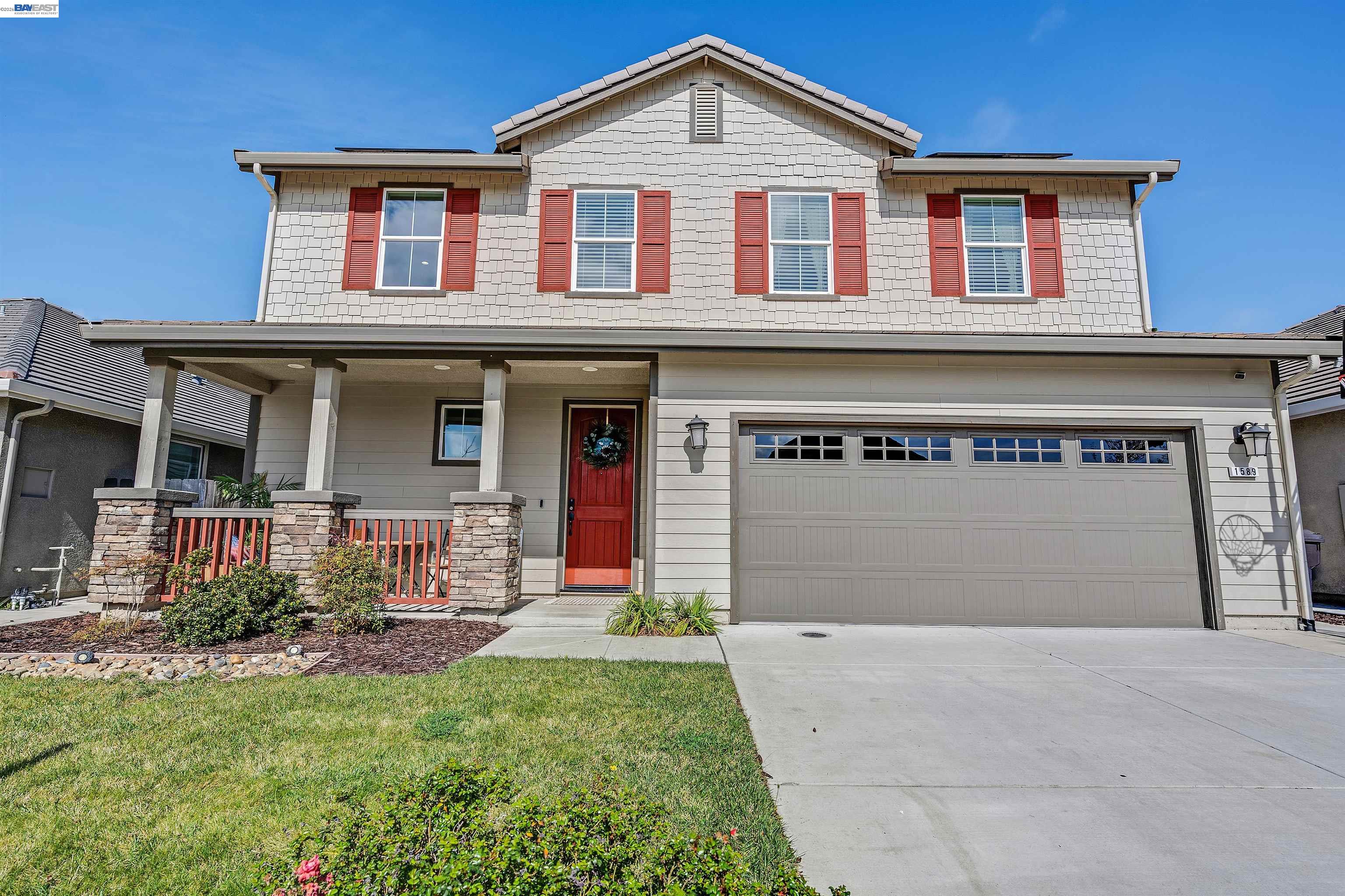 1589 Friendly Street Manteca, CA 95337 - Photo 4 of 50 a front view of a house with a yard and garage
