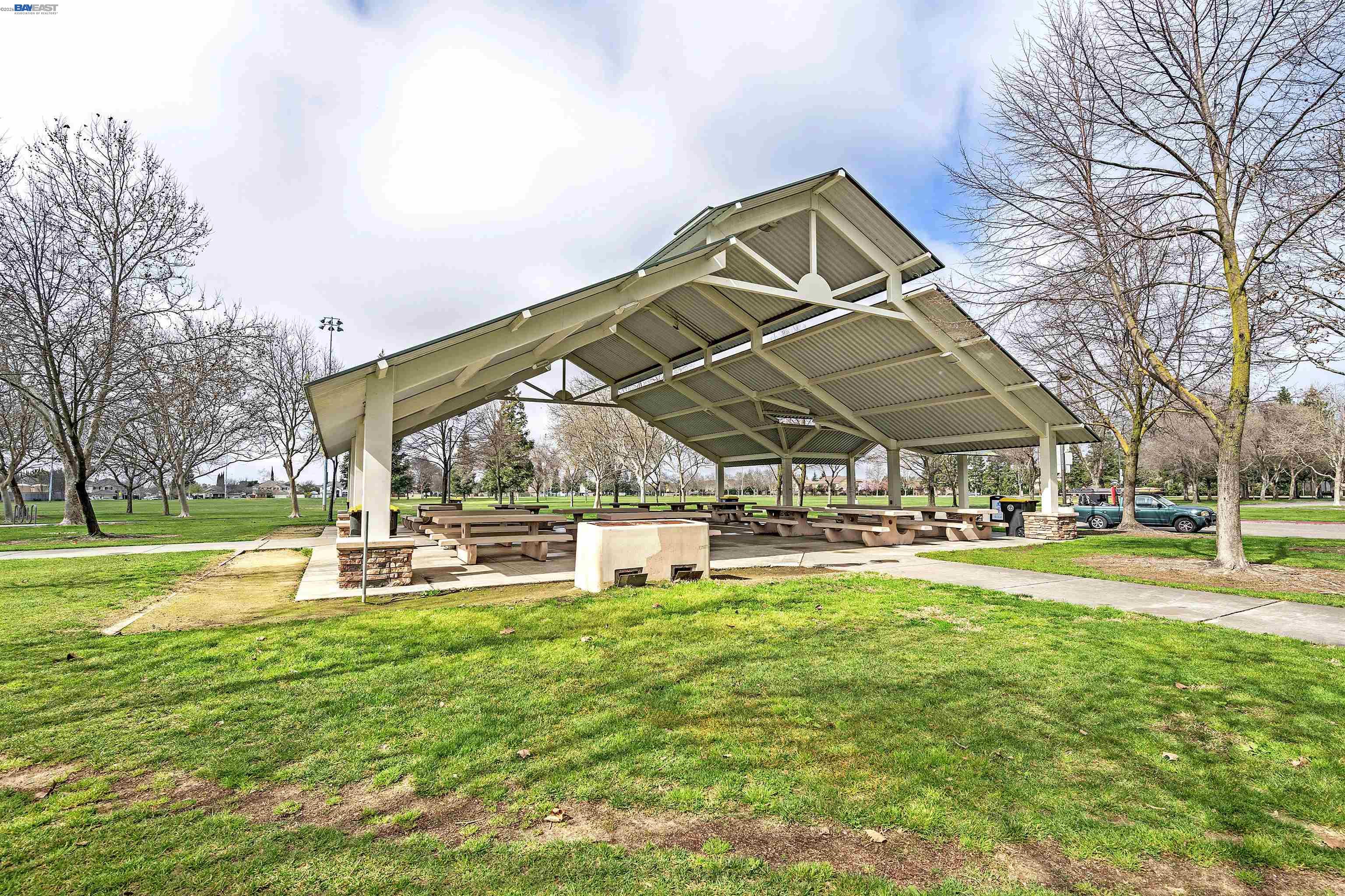 1589 Friendly Street Manteca, CA 95337 - Photo 48 of 50 a view of a swimming pool with a table and chairs under an umbrella
