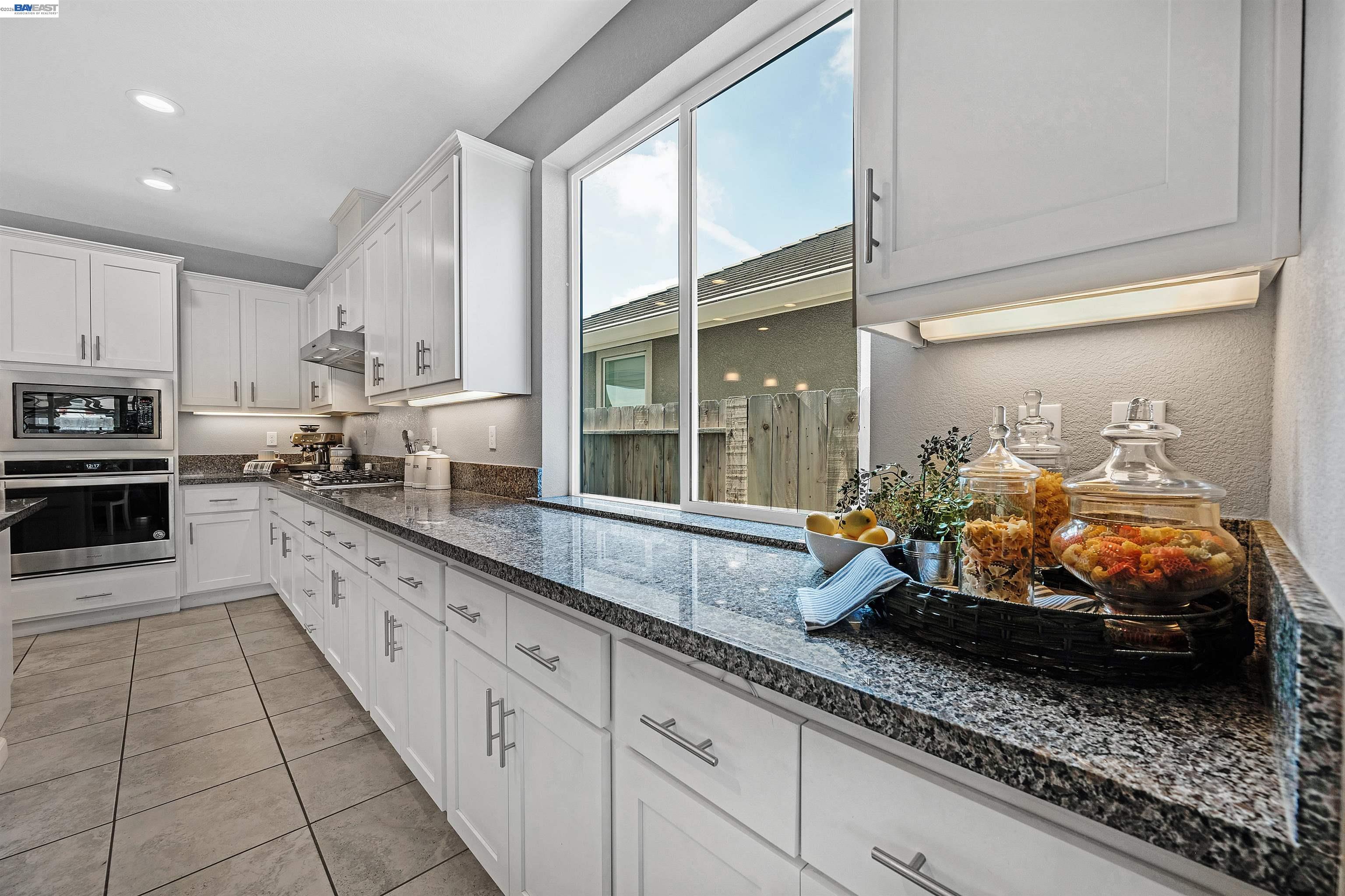 1589 Friendly Street Manteca, CA 95337 - Photo 10 of 50 a large kitchen with kitchen island granite countertop a large window