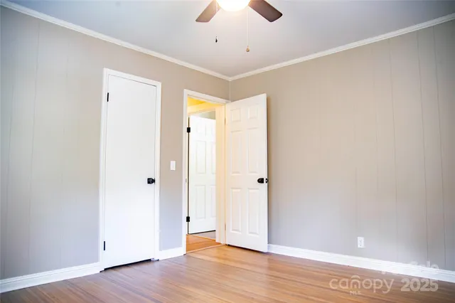 a view of an empty room with wooden floor