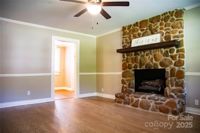 a living room with a fireplace and a flat screen tv