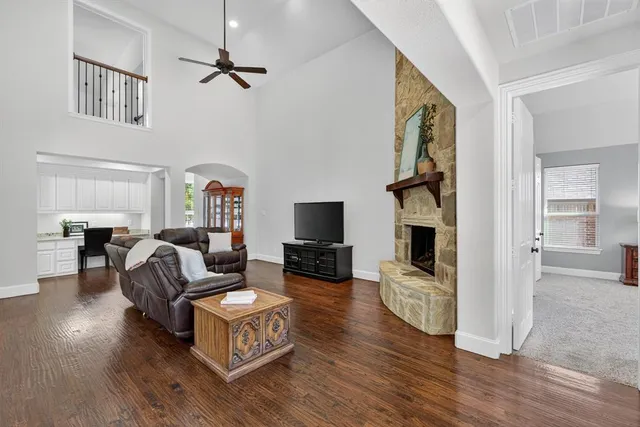 a living room with fireplace furniture and a flat screen tv