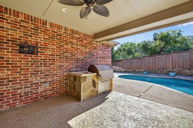 a view of a patio with a table and chairs