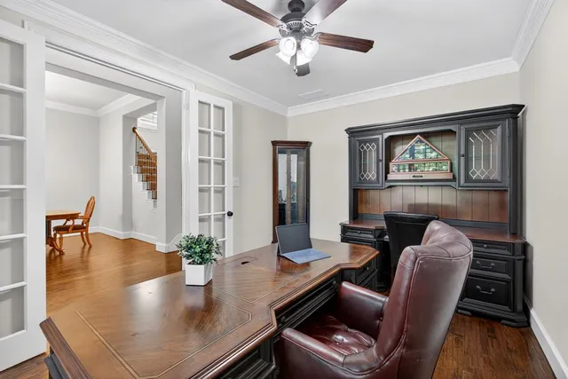 a dining room with furniture and wooden floor