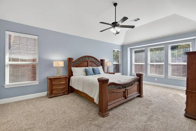 a bedroom with bed and window