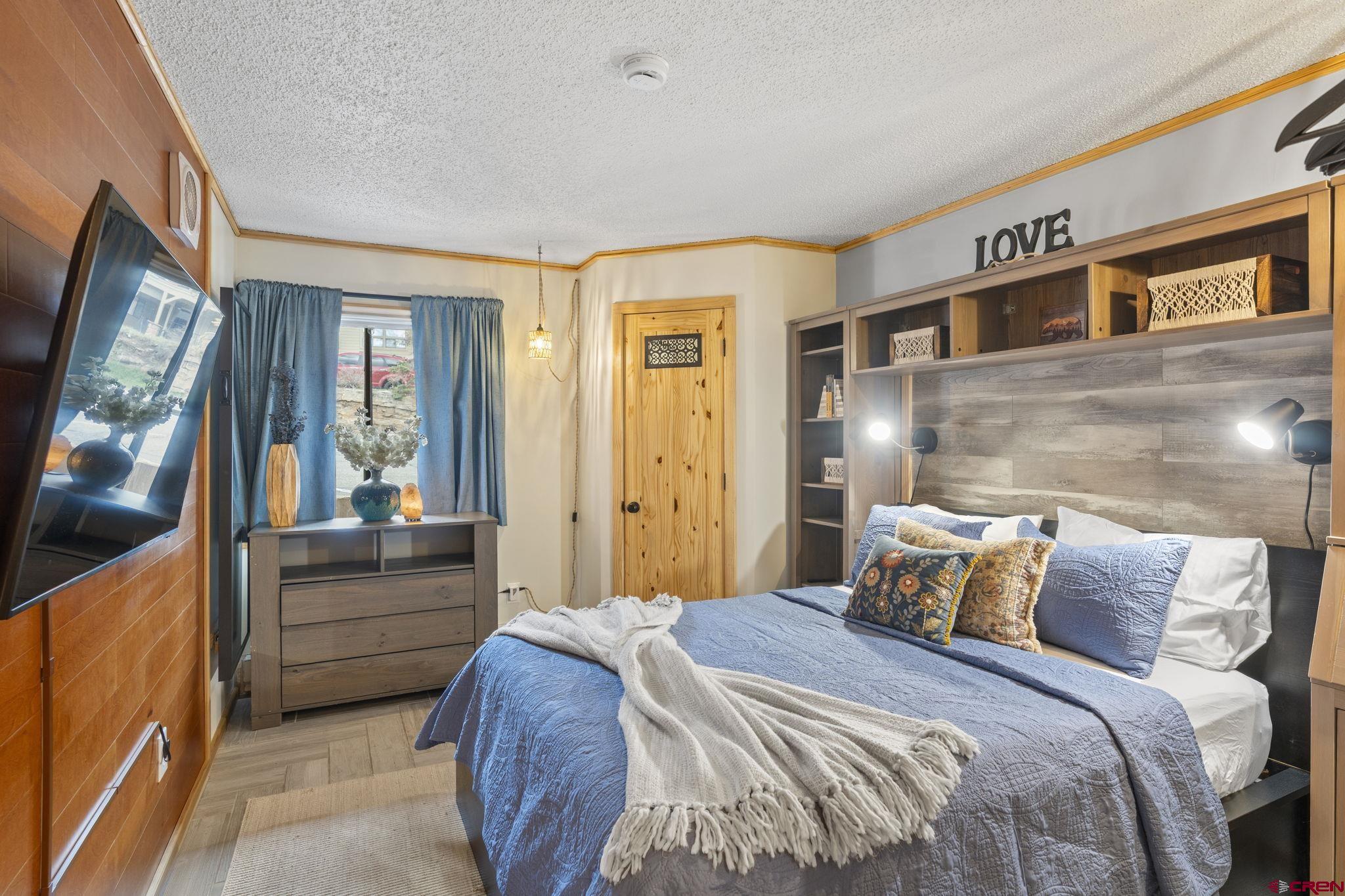 455 Sheol Street, Unit 109 Durango, CO 81301 - Photo 13 of 31 a bedroom with a bed and a large window