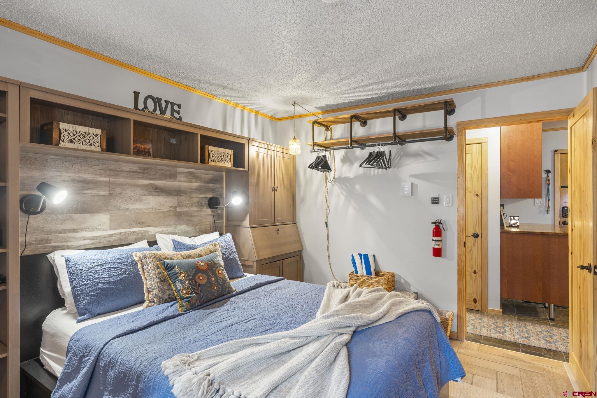 455 Sheol Street, Unit 109 Durango, CO 81301 - Photo 14 of 31 a bedroom with a bed and a mirror