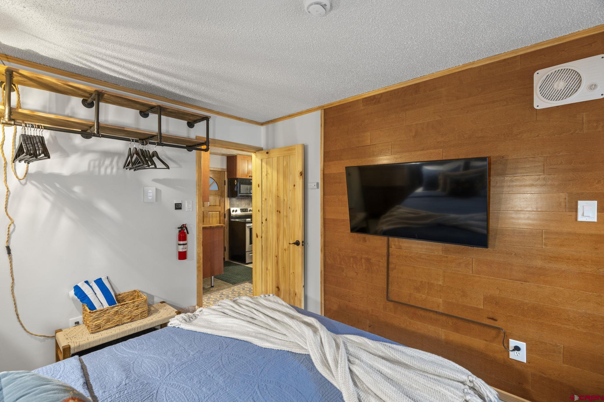 455 Sheol Street, Unit 109 Durango, CO 81301 - Photo 15 of 31 a bedroom with a bed and a flat screen tv