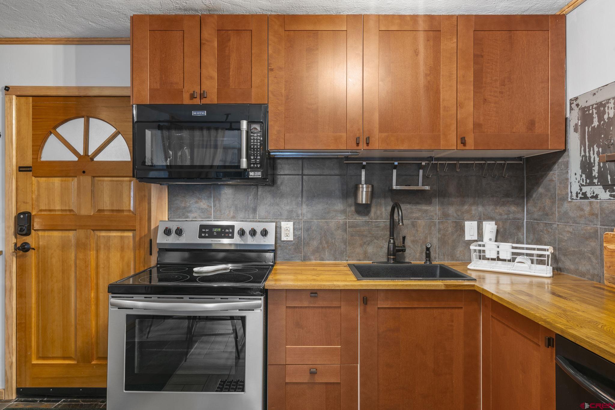455 Sheol Street, Unit 109 Durango, CO 81301 - Photo 10 of 31 a kitchen with stainless steel appliances a stove a sink and a microwave