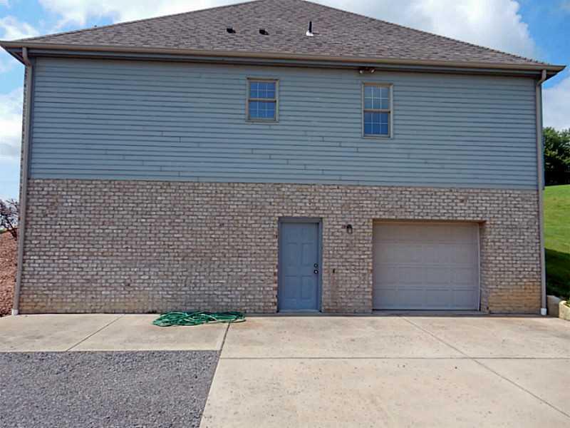 340 Church Road Fombell, PA 16123 - Photo 13 of 19 Exterior Back. GARAGE AND REAR DOOR TO BASEMENT