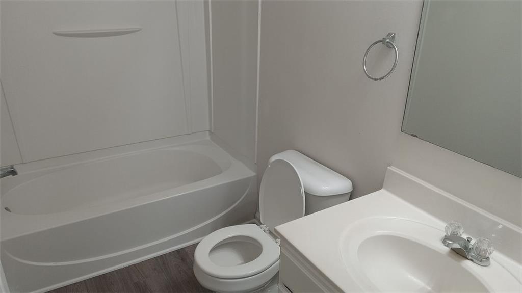 755 Crestwell Circle Atlanta, GA 30331 - Photo 19 of 29 a white toilet sitting next to a bath tub