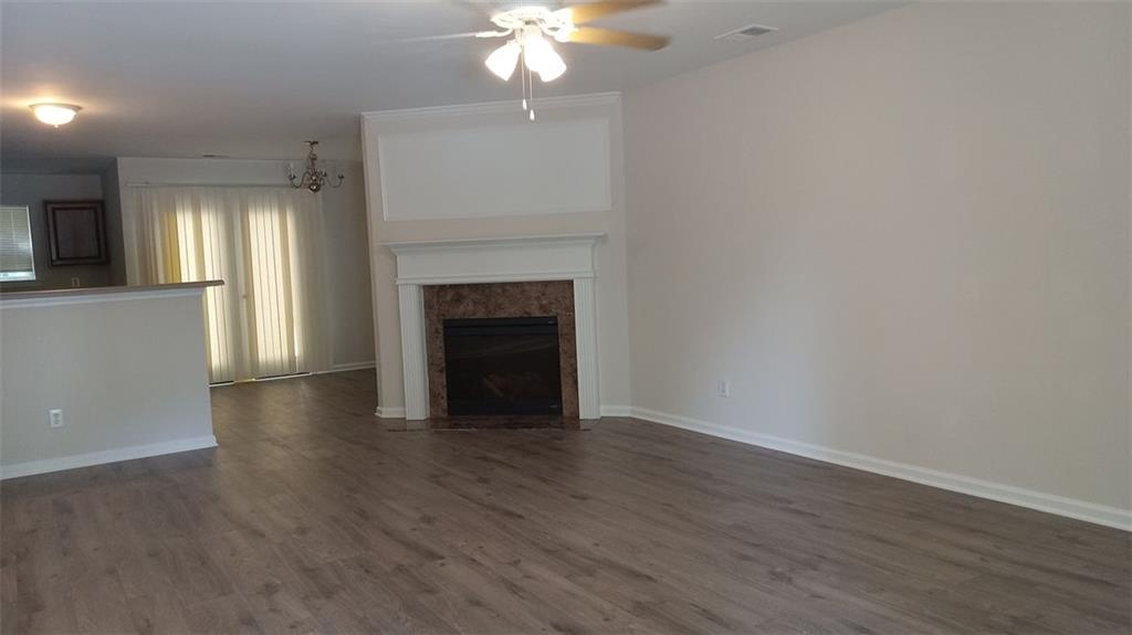 755 Crestwell Circle Atlanta, GA 30331 - Photo 2 of 29 a view of an empty room with wooden floor and a fireplace