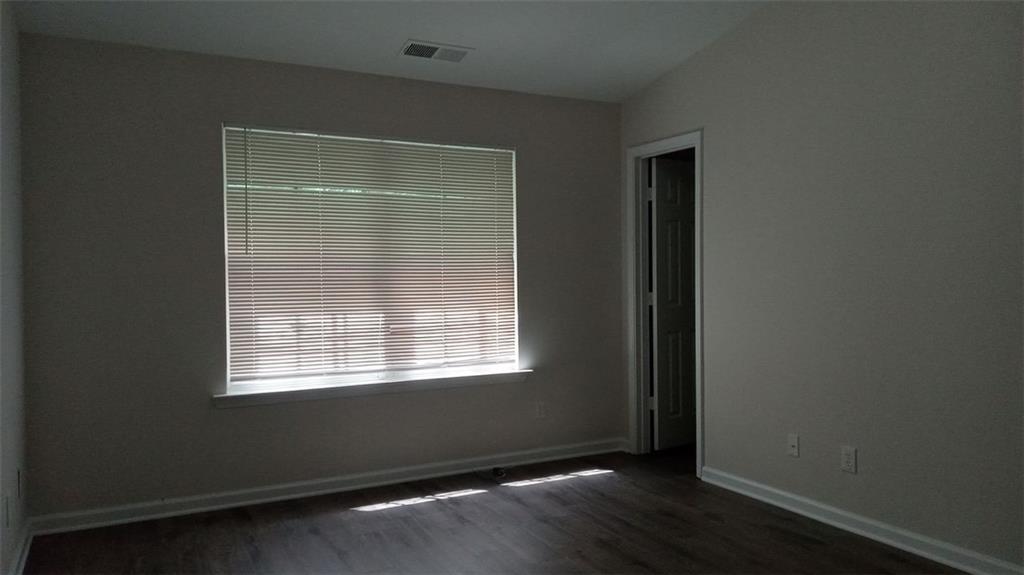 755 Crestwell Circle Atlanta, GA 30331 - Photo 23 of 29 a view of an empty room with wooden floor and a window