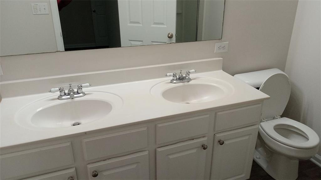 755 Crestwell Circle Atlanta, GA 30331 - Photo 28 of 29 a bathroom with a toilet sink and mirror